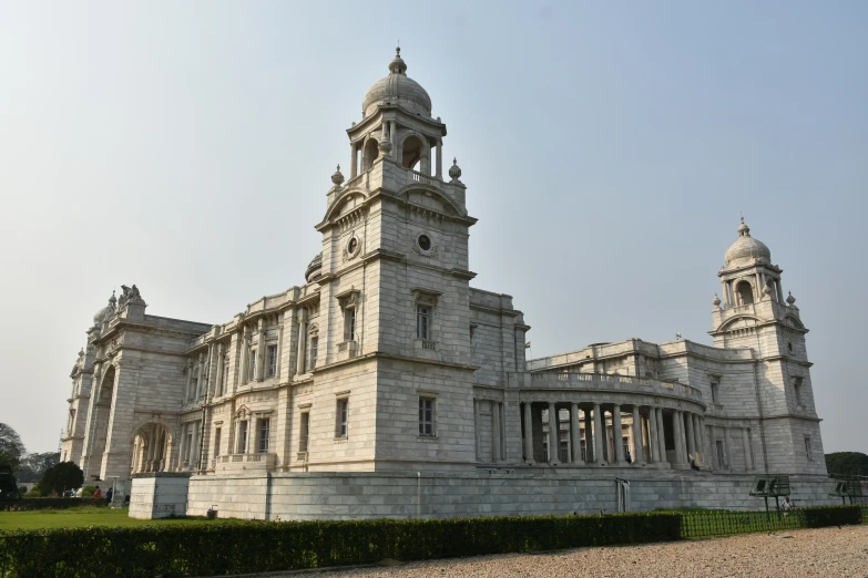 a tall white building with towers on each of it's sides