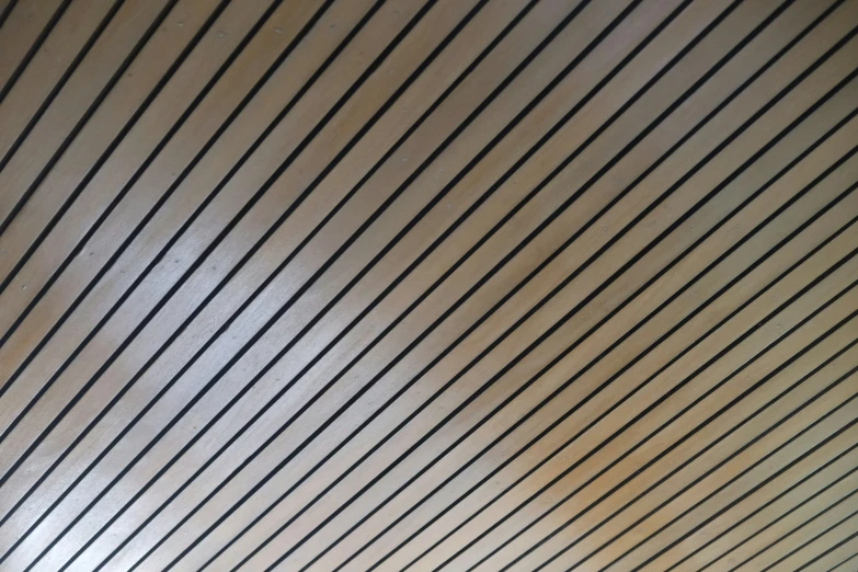 a black and white po of a bench with the lines of a building in the background