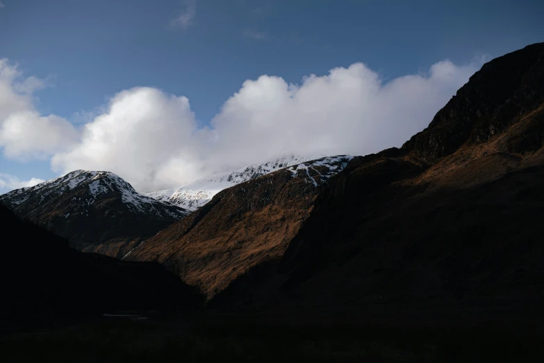 clouds fly over a valley in the mountains