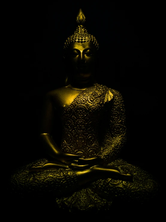 a statue of buddha with gold paint