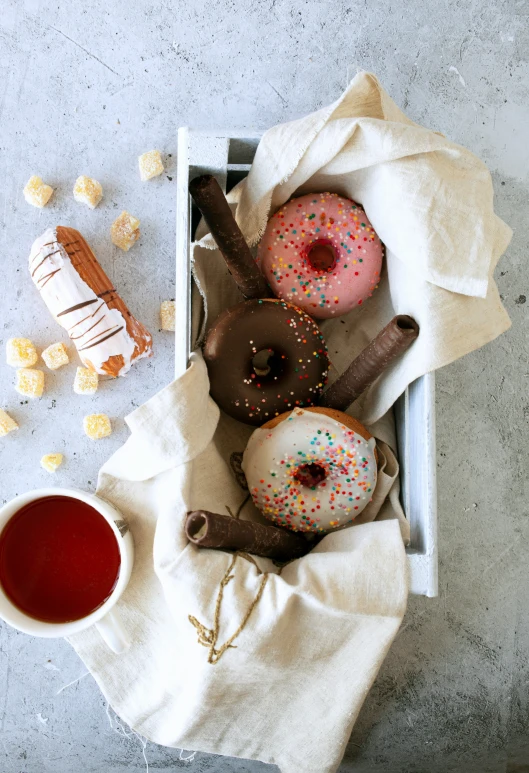 donuts in a box with saucer on the side