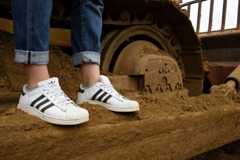 someone standing in front of a mud vehicle