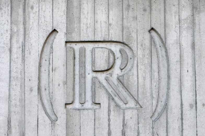 an emblem on a wood panel wall made of concrete