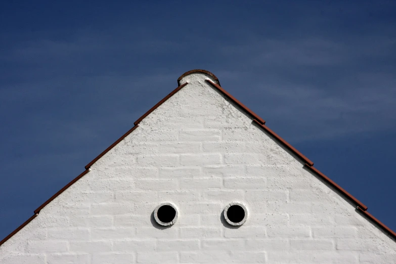 a building with two holes with one eye painted on