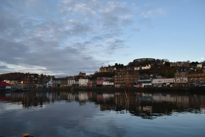 a cloudy sky is shown above the city and harbor