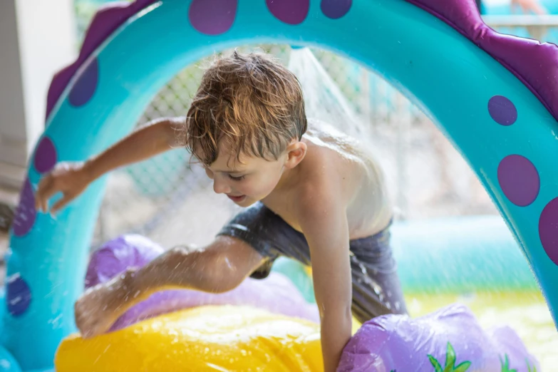 a  is playing in an inflatable water park