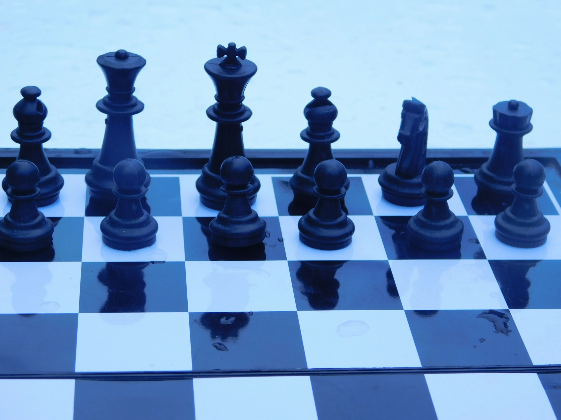 the chess board is sitting on top of a checkerboard