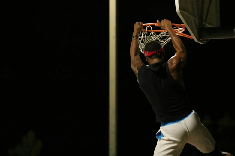 a person is dunking in the basketball hoop