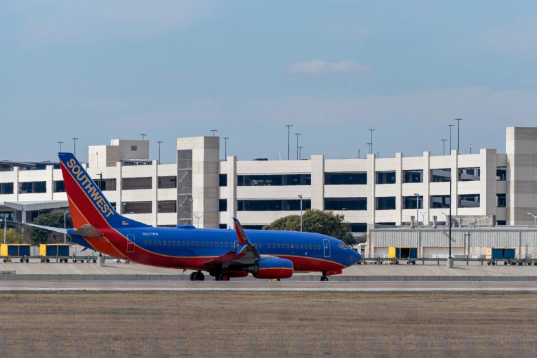 a blue and red airplane parked on the tarmac