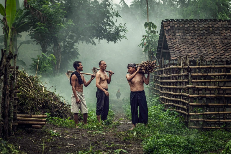 a group of men that are standing around in the woods