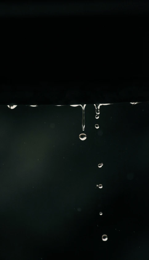 a view of a dark black area, with drops of water dripping