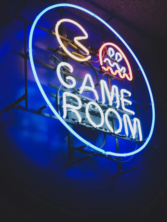 a neon sign for a game room in the dark