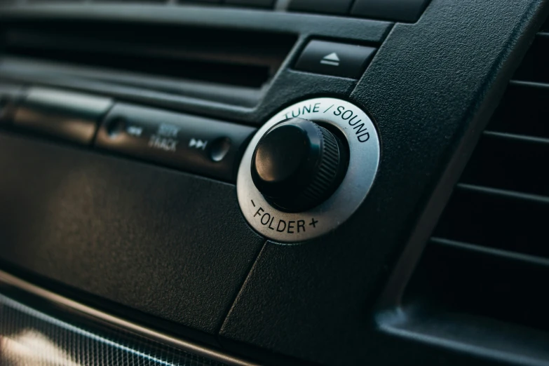 a car air vent on top of a radio
