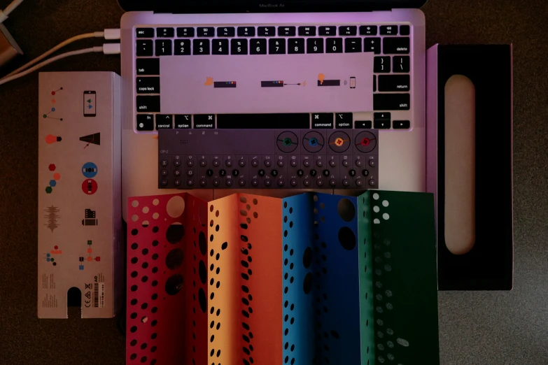 colorful wrapping sheets and a computer keyboard on a desk