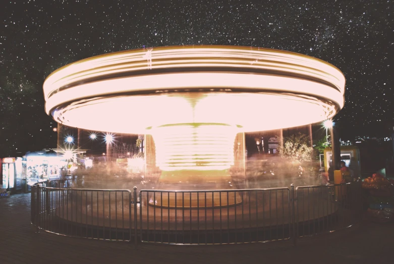 a carousel with the night sky behind it