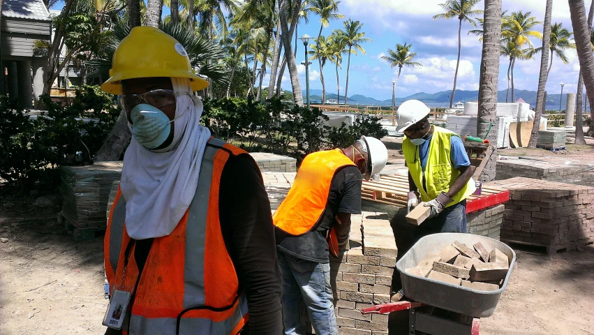 some people are wearing safety vests and hats