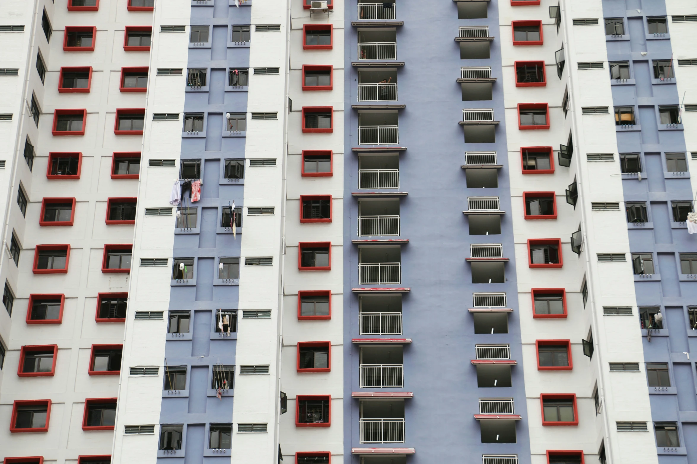 an apartment building with red and blue balconies