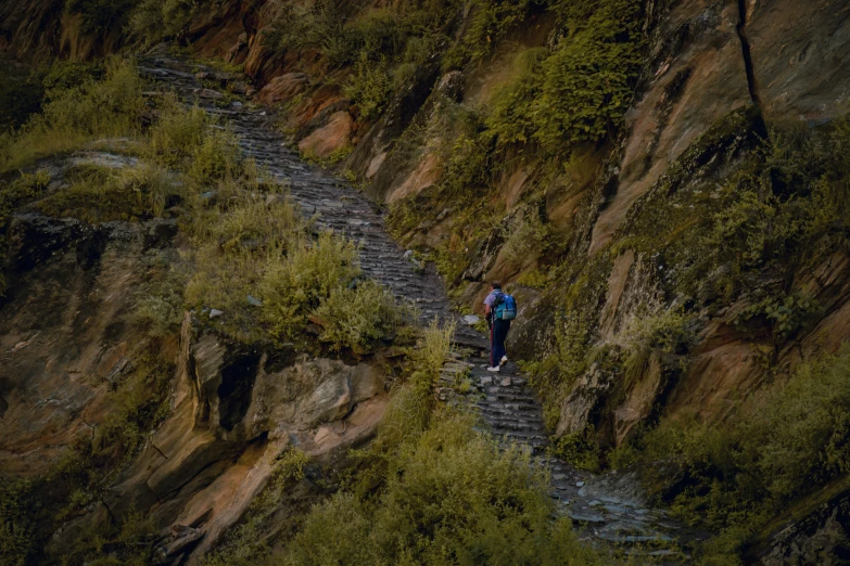 man walking along the edge of a waterfall