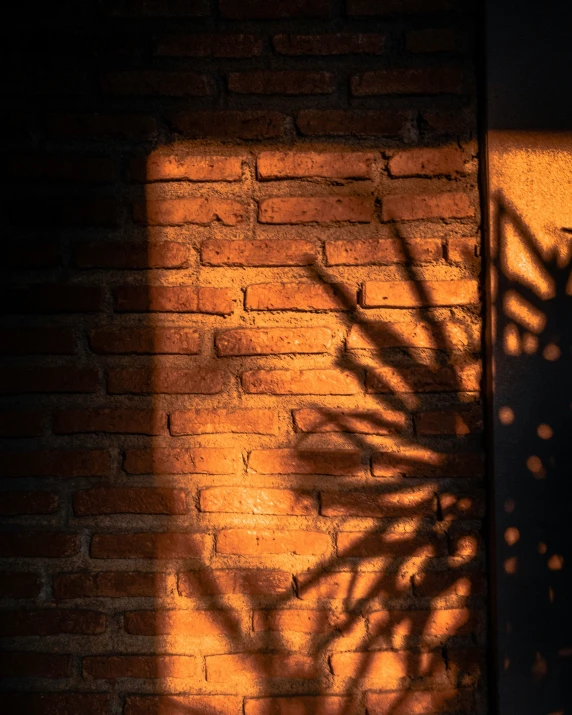 a brick wall with a shadow cast on it