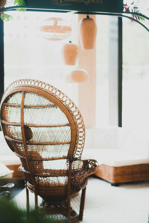 a wicker chair sitting next to an open window