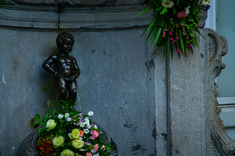 a statue with flowers on it in a flower display