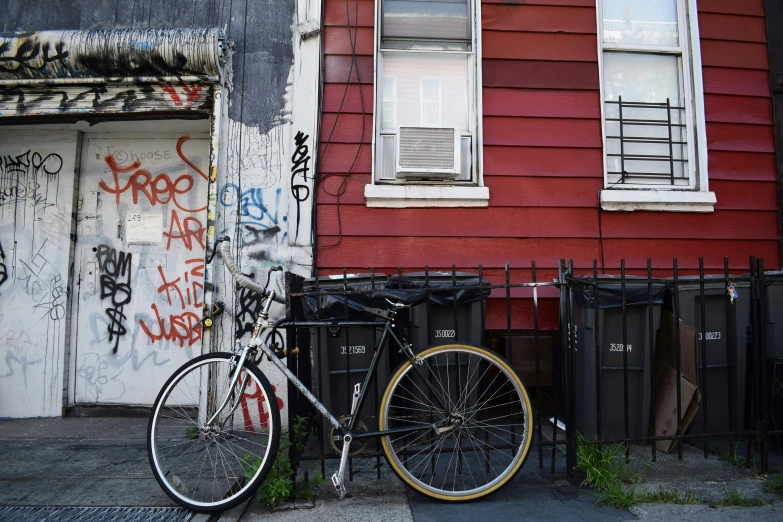 two bicycles leaning against a wall and some graffiti