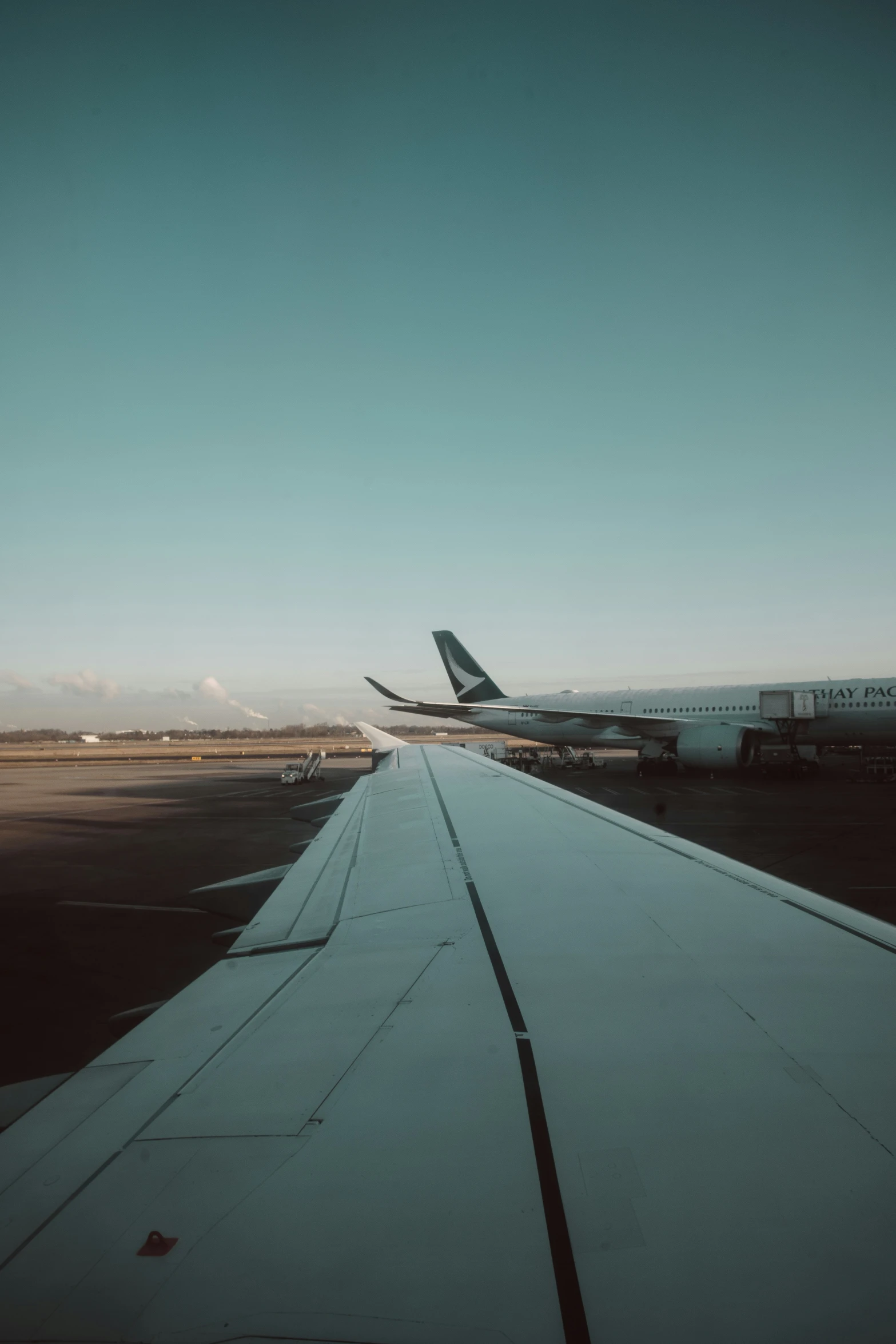 an airplane wing sitting on top of an airport runway