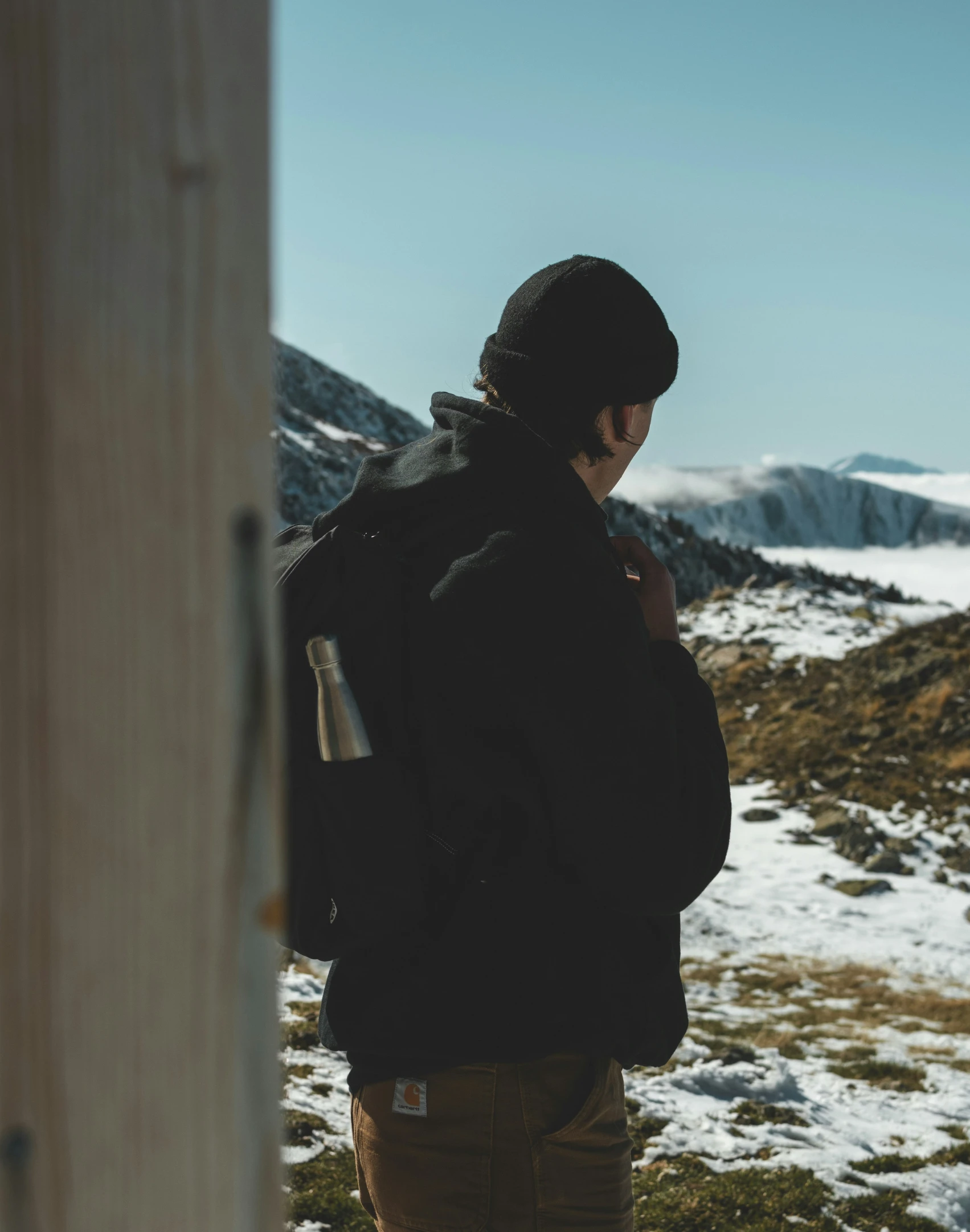 a man standing outside talking on his cell phone