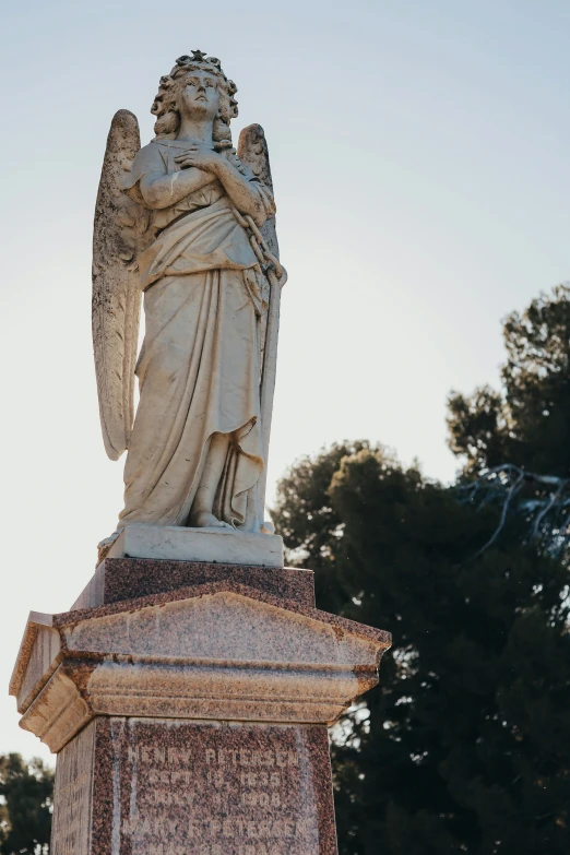 statue that is sitting up against the sky