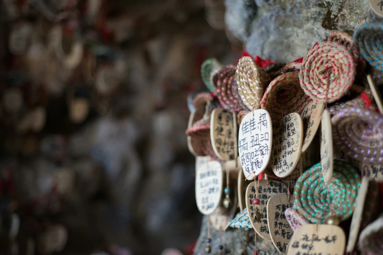 several hand - made tags on a rock wall, which reads, we are the most popular tourist's