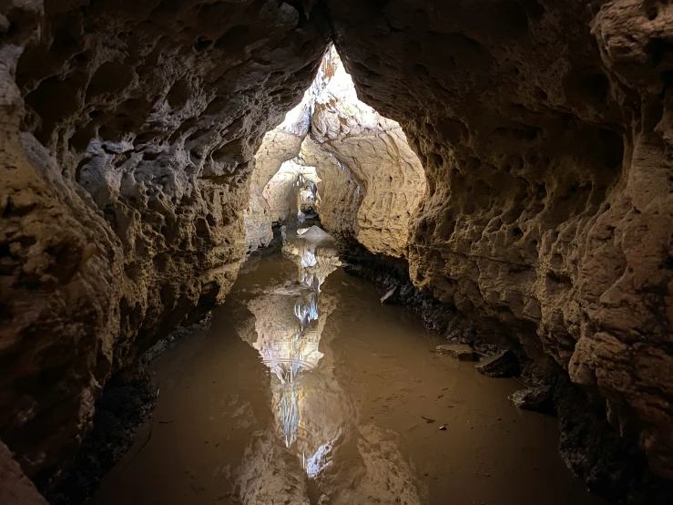 there is a narrow pathway to the water inside the cave