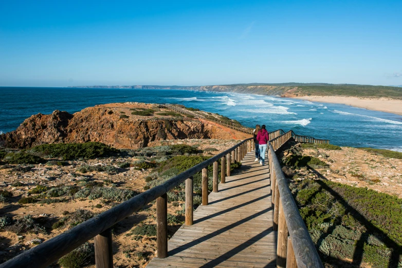 a person walking up the steps near the beach