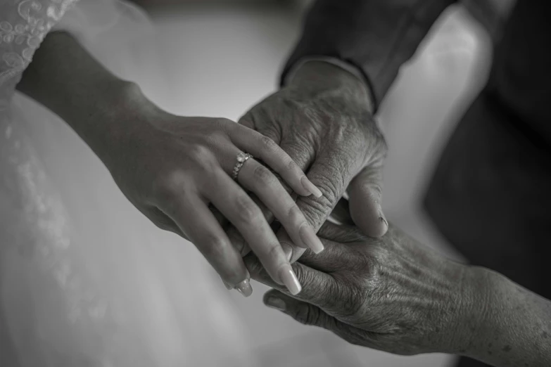 two people hold hands during a ceremony