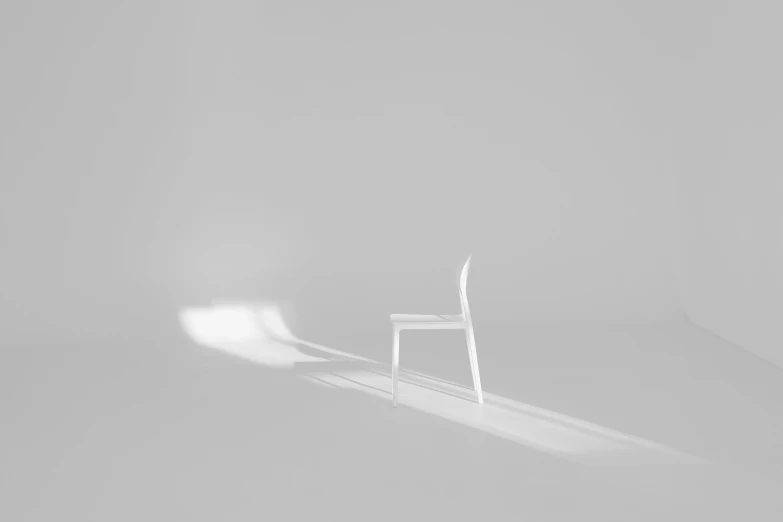 an empty chair and a half empty chair against a light background