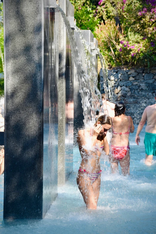 several people playing in the water at a park