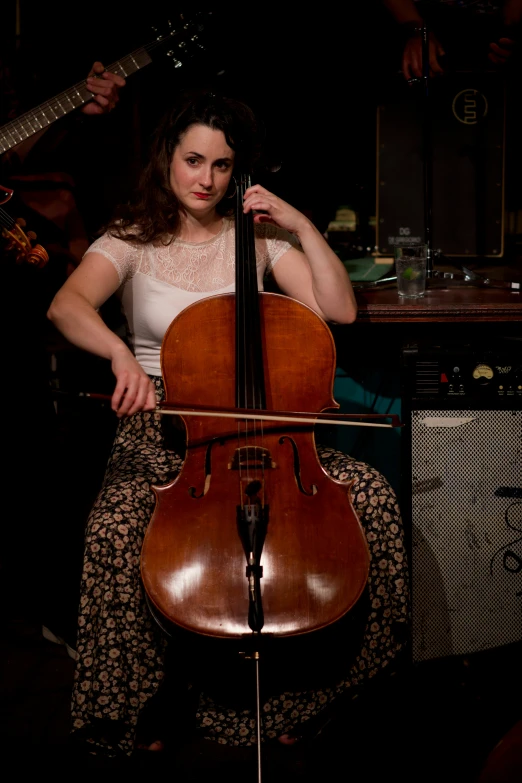 a woman is holding onto an instrument in the dark