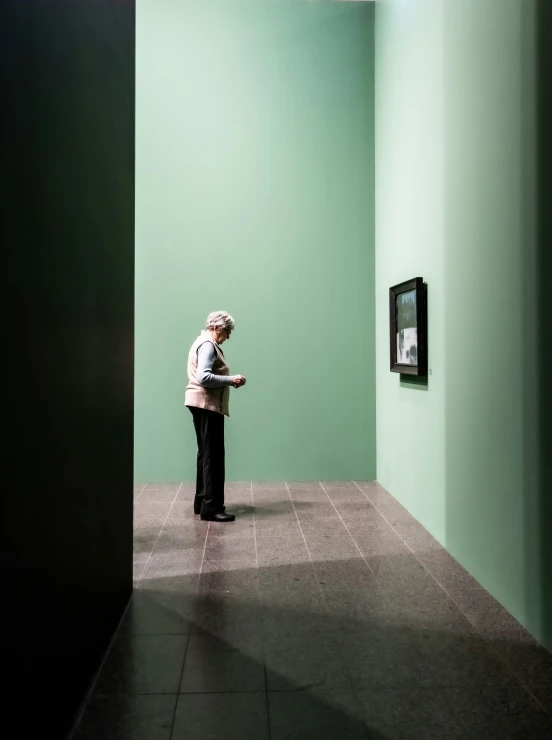 a person standing in a room next to a wall