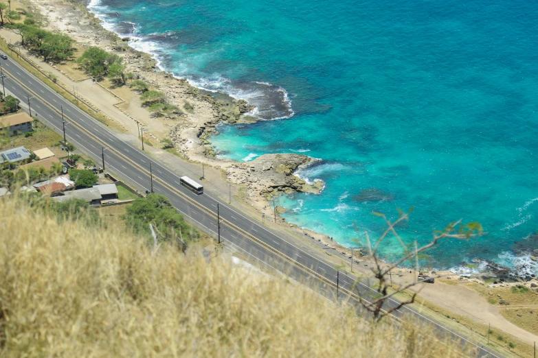 an aerial view shows a road and the ocean