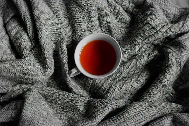 cup of tea on grey linen as background