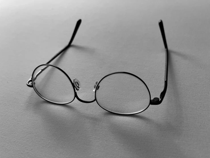 glasses sitting up against a white background