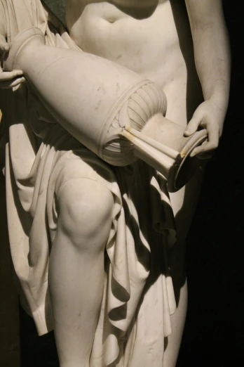 a statue of a female holding a book