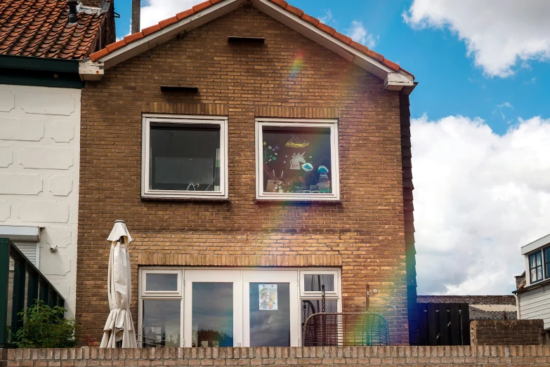 a statue is in front of a brick house