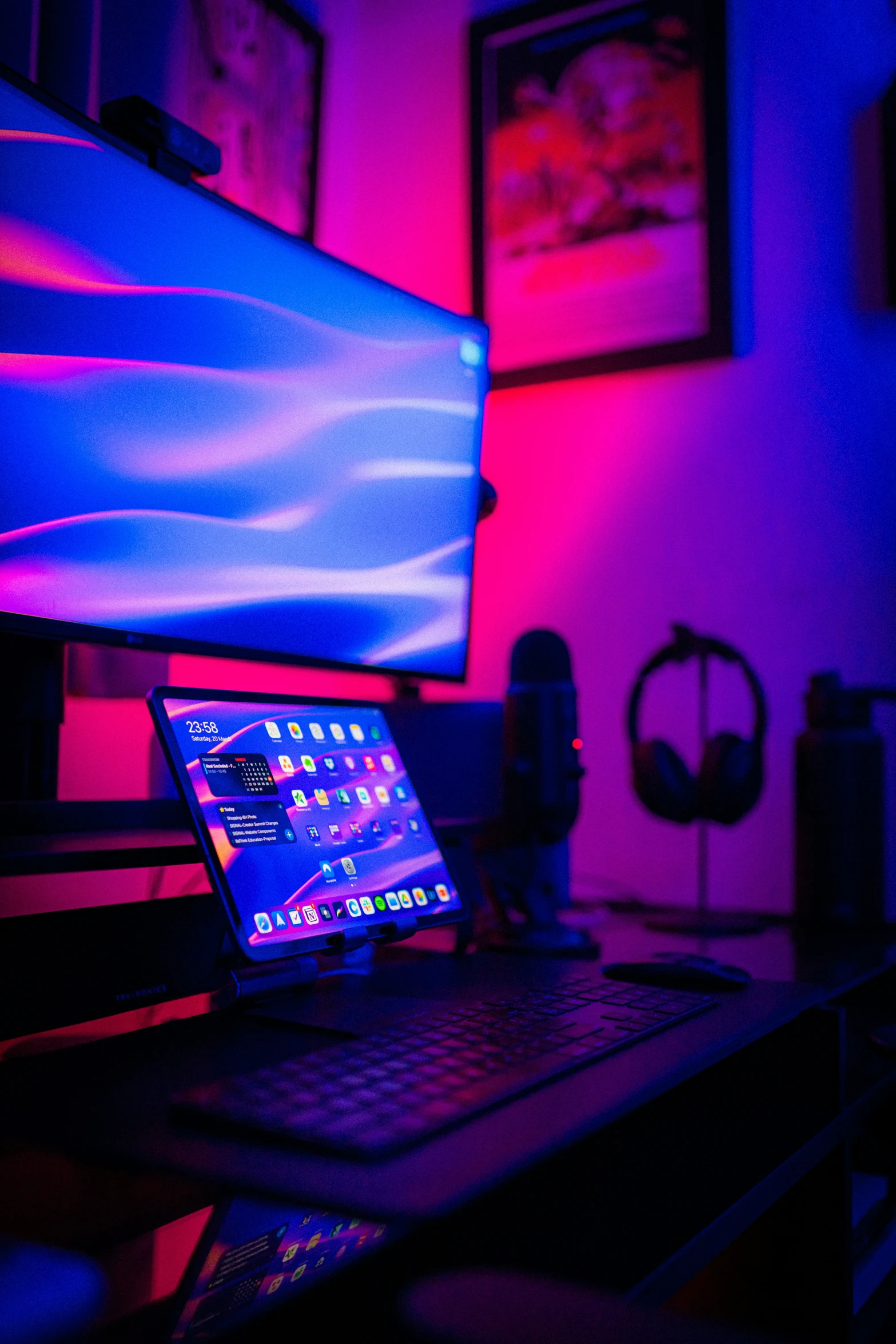 laptop in front of two pictures with purple lights