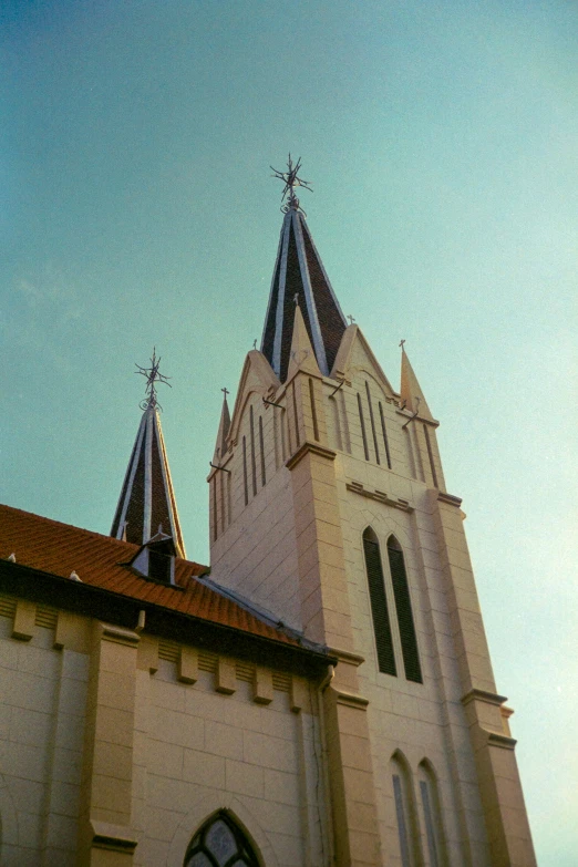 a large church with two spires in front of a building