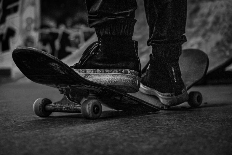 black and white po of feet on a skateboard