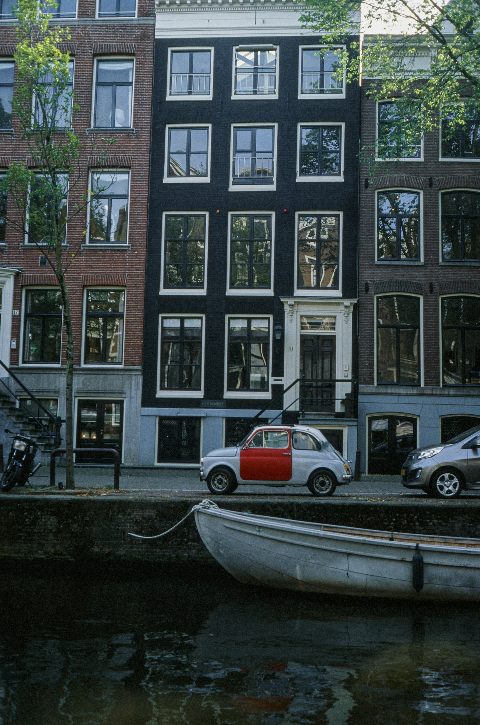 a boat sitting on a river next to buildings