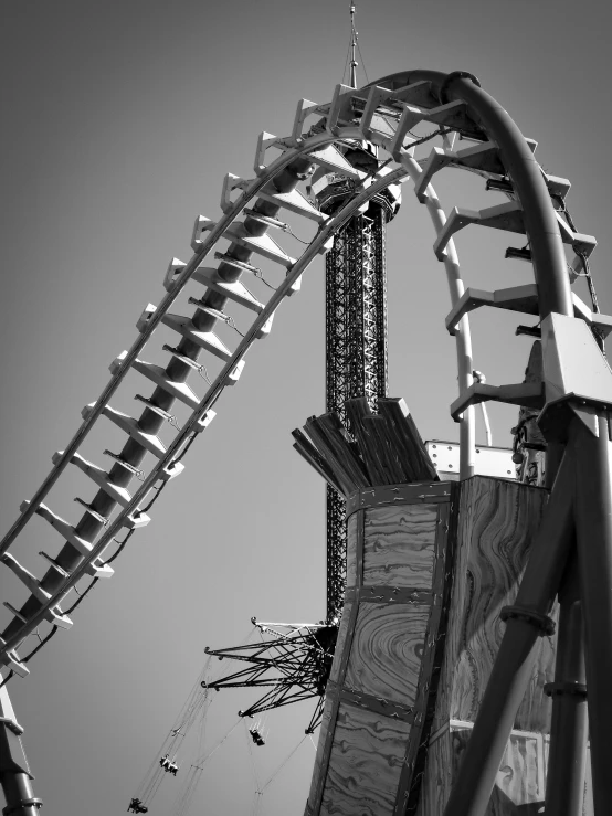 black and white pograph of a roller coaster at a carnival