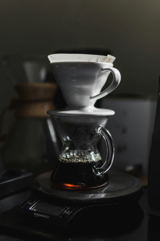 four pour - over pots are stacked on top of each other