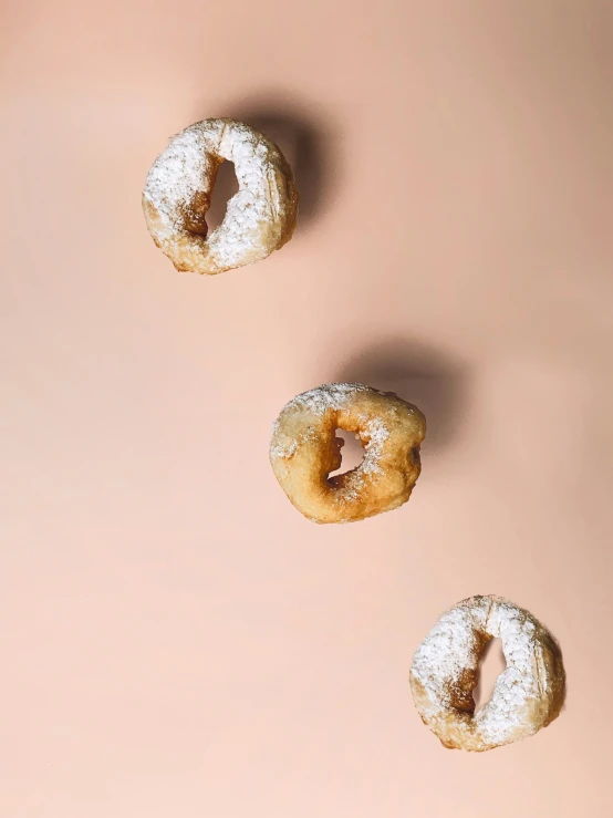 three donuts are lying together in the same direction