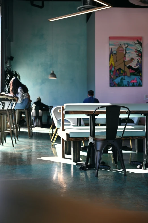 a restaurant with tables and chairs on both sides of them